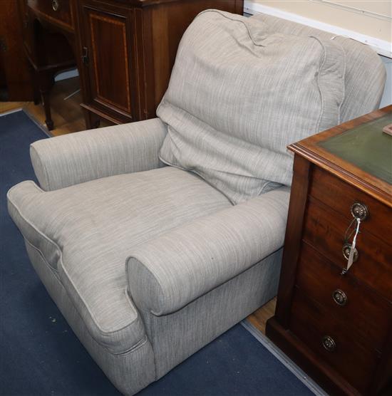 An armchair upholstered in slate colour fabric